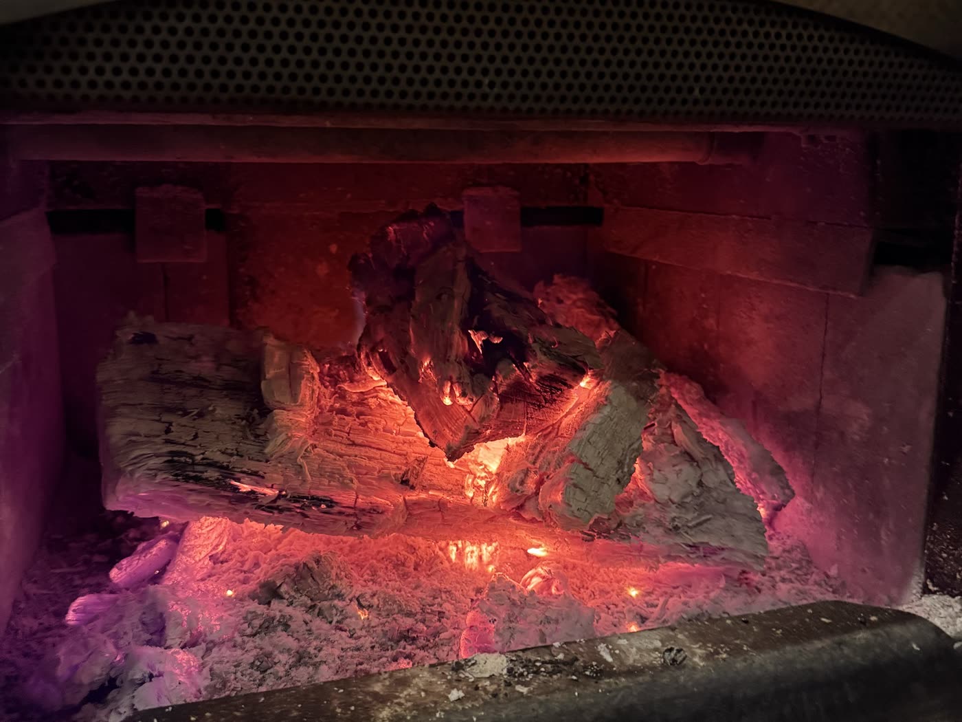 Glowing coals in the cabin's wood stove