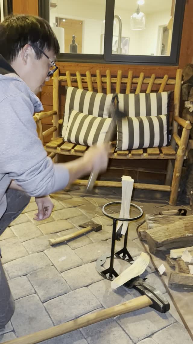 Dylan mid-swing at the kindling splitter