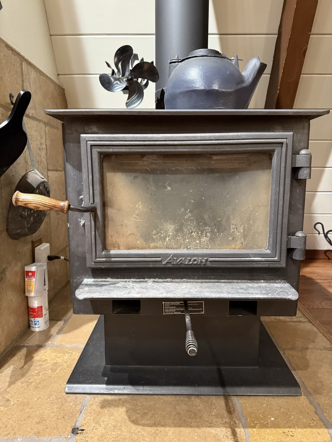 The Avalon wood stove with a fan and kettle on top