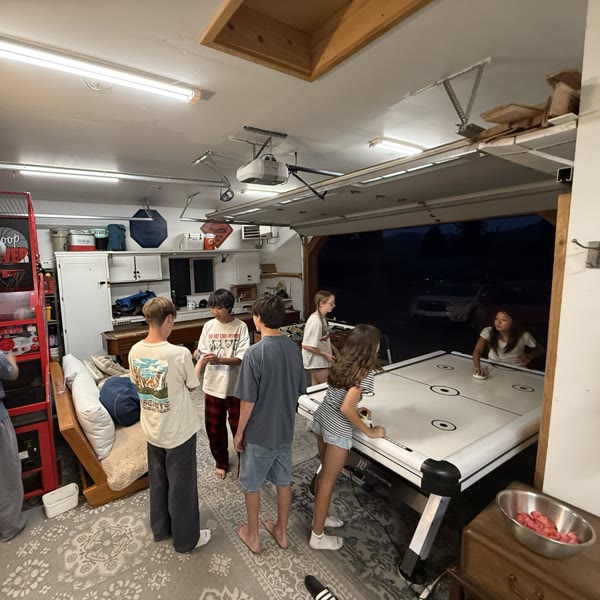 Kids crowded around the air hockey table on a summer night